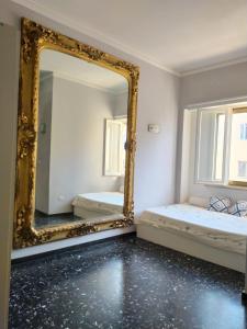 a mirror in a room with two beds at Antichi Riflessi suite in Cagliari