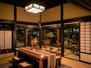 a living room with a table and some windows at Chousenkaku Kameya in Shimo-suwa