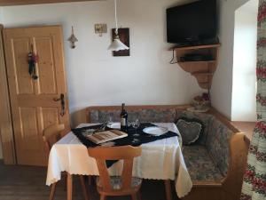 a dining room with a table and a couch at Tschurtschenthalerhof am Ort in San Giuseppe