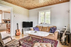 a living room with a couch and a table at Charming and rural cottage in Ockelbo in Ockelbo