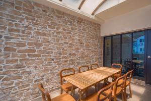 a dining room with a wooden table and chairs at Namsan Hill Hotel in Seoul
