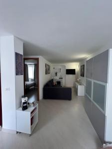 a living room with a black couch in a room at Casa Caia in Genoa