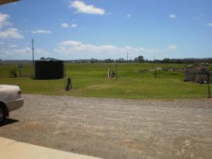 a field with a tent in the middle of it at Country View Motel Ilbilbie in Ilbilbie