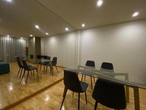 a conference room with a glass table and chairs at Apartments Atlantis by UR in Vila Nova de Gaia