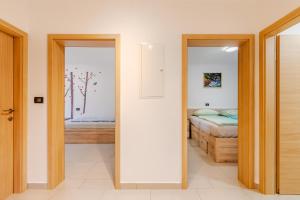 a bedroom with a bed and a door with a mirror at Penzion Hosnar, hiša Mišc in Bovec