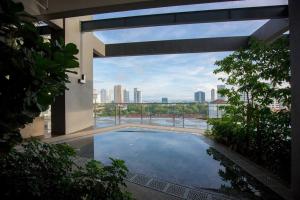 a swimming pool in a building with a view of a city at Tropicana 218 Spacious Luxury City 3BedRoom 3 Car park 11pax in George Town