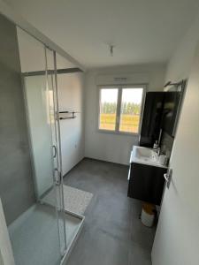 a bathroom with a shower and a sink at Villa les Tonnelles 1 à 800m de la plage et 500m de la forêt in Saint-Jean-de-Monts +28 photos