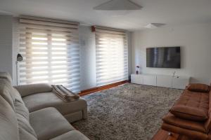 a living room with a couch and a flat screen tv at Kato kale in Bermeo