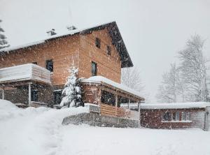 a building covered in snow in front at Almliesl GAST-719 in Bad Gastein +4 photos