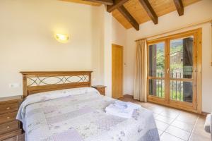 a bedroom with a bed and a sliding glass door at Casa Irene in Calvera