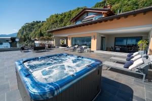 a hot tub on the patio of a house at Villa Navalia in Menaggio
