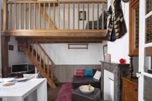 a room with a staircase and a living room at Le Petit Mont by Cocoonr in Rennes +10 photos