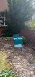 a blue table sitting on a patio in a yard at La pavillonnaise in Les Pavillons-sous-Bois