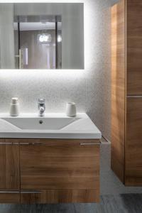 a bathroom with a white sink and a mirror at Kato kale in Bermeo