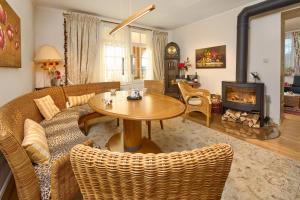 a living room with a table and chairs and a fireplace at Landhaus-Apartment Feldbergblick in Sankt Märgen