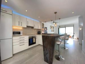 a kitchen with white cabinets and a black counter top at Comfortable House in Mojácar with Shared Pool in Mojácar