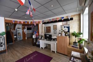 a store with flags hanging from the ceiling at Hôtel Le Bayeux in Bayeux