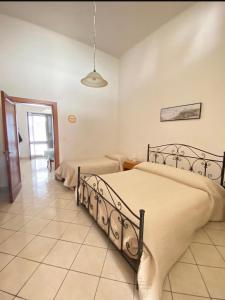 a bedroom with a large bed and a hallway at La casa di Neve in Santa Maria al Bagno