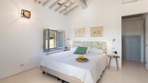 a white bedroom with a bed with a tray on it at VILLA IL POZZO 14, Emma Villas in Pomarance +38 photos