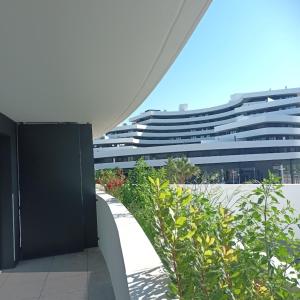 a view of a large building from a balcony at Cosy Diem Cap d'Agde in Cap d'Agde