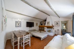 un soggiorno con tavolo e divano di Cottage Pura Vigna immerso nella natura vicino al mare a Porto Santo Stefano