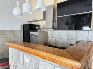 a kitchen with a wooden counter top in a kitchen at Apartments Lungo Mare in Sveti Stefan