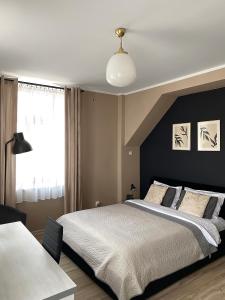 Posteľ alebo postele v izbe v ubytovaní H-T-L Apartamenty Junior