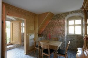 a dining room with a wooden table and chairs at Sonnenschloss in Walbeck