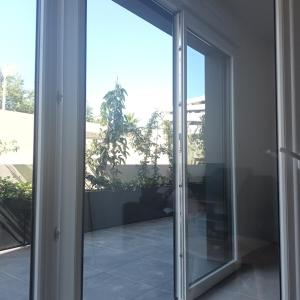 an open sliding glass door in a house at Cosy Diem Cap d'Agde in Cap d'Agde