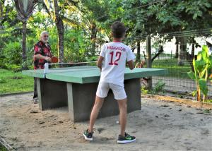 a young man playing a game of table tennis at 4 bedrooms villa with sea view enclosed garden and wifi at Foulpointe Madagascar in Foulpointe