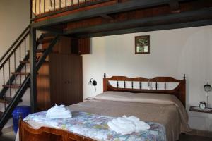 a bedroom with a loft bed with towels on it at La Dimora del Passato B&B in Castellone