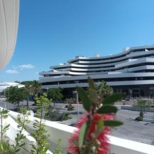 a parking lot with a large building in the background at Cosy Diem Cap d'Agde in Cap d'Agde