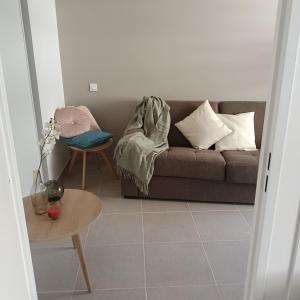 a living room with a couch and a table at Cosy Diem Cap d'Agde in Cap d'Agde