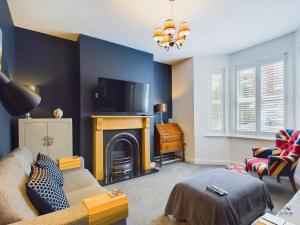 a living room with a couch and a fireplace at Seaside Cottage, Moments from Ryde's Golden Sands, Sleeps 4 in Ryde
