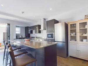 a kitchen with a large island in the middle at Seaside Cottage, Moments from Ryde's Golden Sands, Sleeps 4 in Ryde