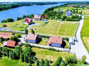 an aerial view of a house on a hill next to a river at Dom letniskowy ORCHIDEA in Chrzanowo