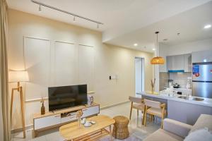 a living room with a tv and a kitchen at Trion Kuala Lumpur by Cobnb in Kuala Lumpur