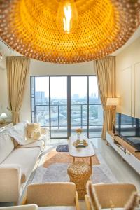 a living room with a large chandelier at Trion Kuala Lumpur by Cobnb in Kuala Lumpur