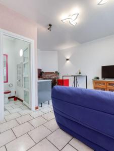 un soggiorno con un divano blu e una cucina di Samois-sur-seine Superbe appartement - Rickhoss Home a Samois-sur-Seine