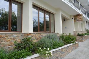 a building with windows and plants in front of it at Xanemos Studios in Skiathos
