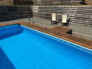 two chairs sitting next to a swimming pool at I Due Ulivi in Calice al Cornoviglio