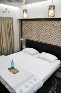a bedroom with a bed with a tray on it at Kalpattaru Sadan Luxurios 3BHK in Pune