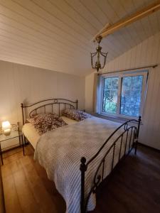 a bedroom with a bed and a window at Šventoji in Palanga