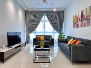 a living room with a couch and a tv at Paradigm Residence Johor Bahru in Johor Bahru