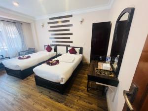 Rúm í herbergi á Hotel Liv Inn