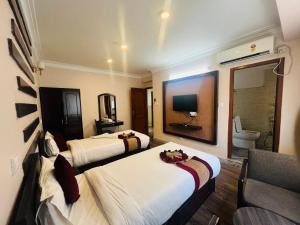 Rúm í herbergi á Hotel Liv Inn