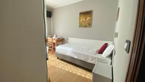 niewielka sypialnia z łóżkiem i stołem w obiekcie Casteluce Hotel Funivie w mieście Pinzolo