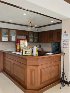 a large wooden counter in a kitchen with a camera at Bella Bella Riverview in Bangkok