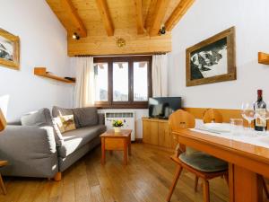 a living room with a couch and a table at Apartment Residenza Chesa Margun 59-4 by Interhome in Surlej