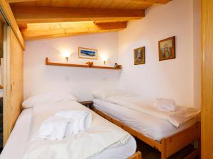 three beds in a room with wooden ceilings at Apartment Residenza Chesa Margun 59-4 by Interhome in Surlej +18 photos